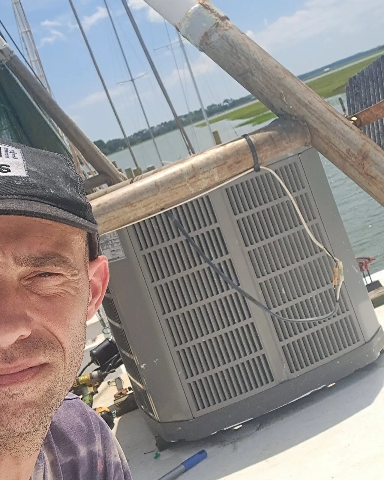 Outdoor air conditioning condenser on a waterfront roof deck